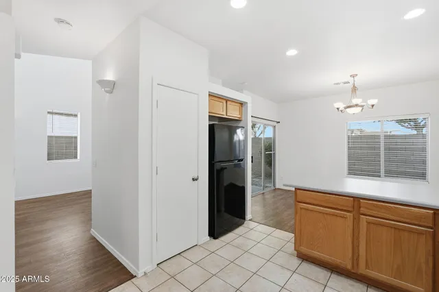 a kitchen with stainless steel appliances granite countertop a sink and stove top oven with wooden floor