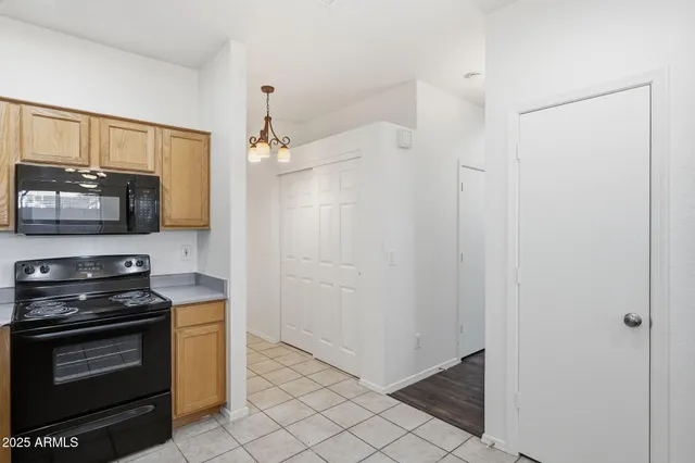 a kitchen with a sink window and cabinets