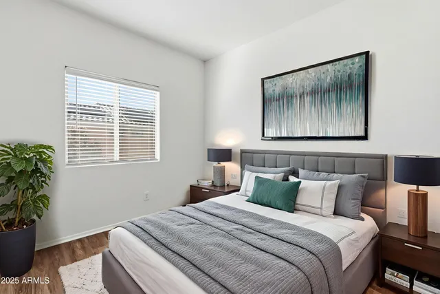 a bedroom with a bed and a potted plant