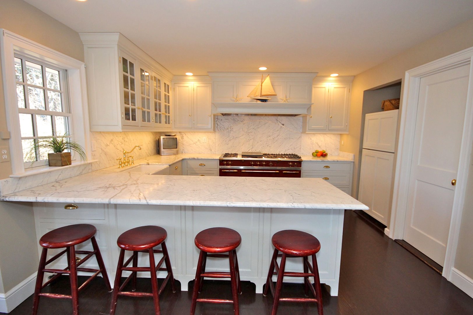 9 Fowler Avenue Edgartown, MA 02539 - Photo 14 of 28 a kitchen with stainless steel appliances a dining table and chairs