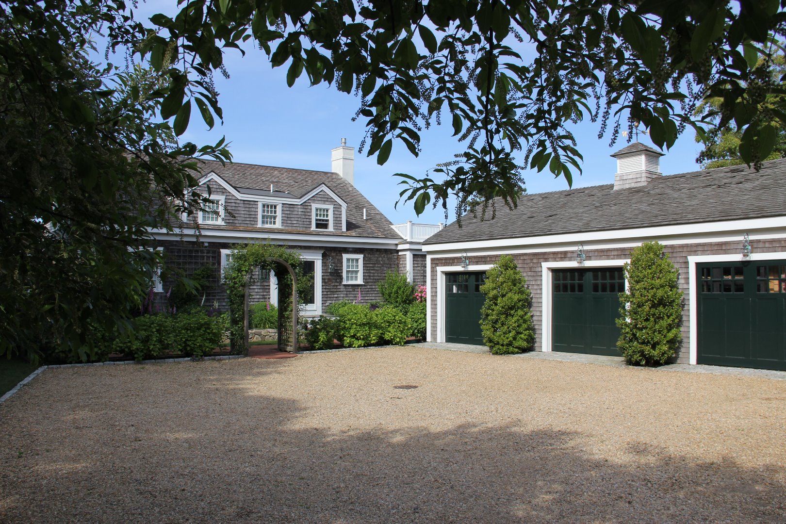 9 Fowler Avenue Edgartown, MA 02539 - Photo 3 of 28 a front view of a house with a garden
