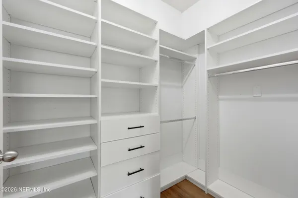 a view of a closet area with en suite bathroom