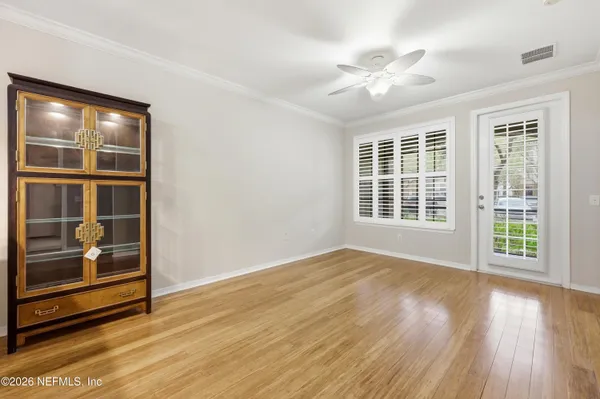 wooden floor in an empty room with a window