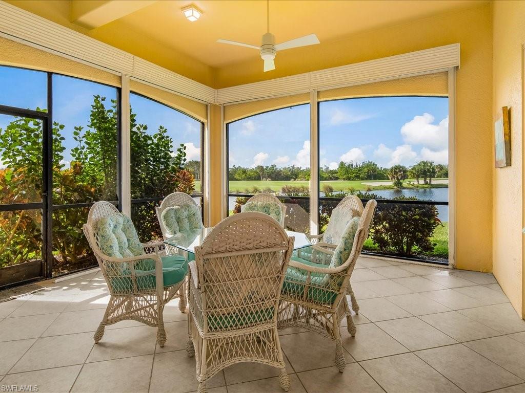 1498 Borghese Lane, Unit 101 Naples, FL 34114 - Photo 11 of 34 a view of a chair and tables in the patio