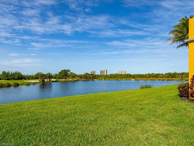 a view of a lake with houses in the back