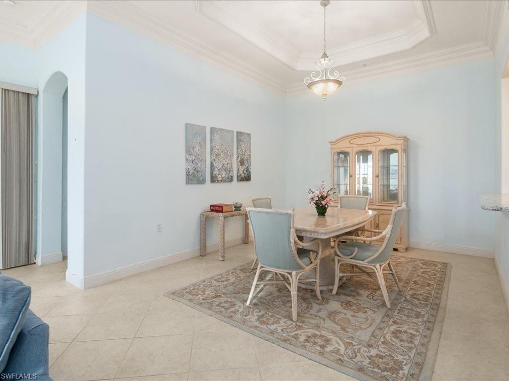 1498 Borghese Lane, Unit 101 Naples, FL 34114 - Photo 14 of 34 a dining room with furniture and window