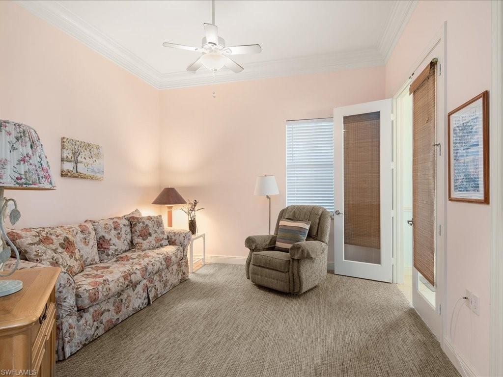 1498 Borghese Lane, Unit 101 Naples, FL 34114 - Photo 18 of 34 a living room with furniture and a chandelier