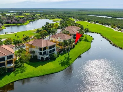 an aerial view of a house with a garden and lake view