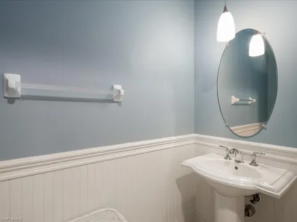 a bathroom with a sink a vanity and a mirror