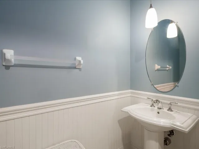 a bathroom with a sink a vanity and a mirror