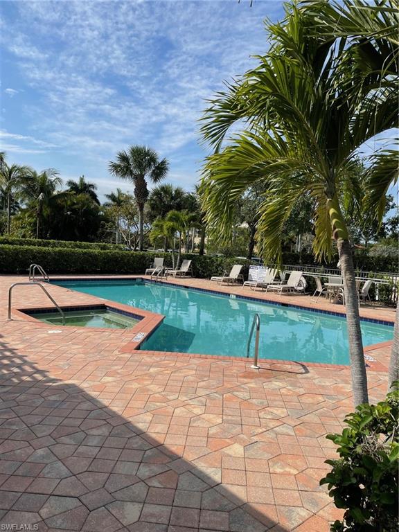 1498 Borghese Lane, Unit 101 Naples, FL 34114 - Photo 26 of 34 a view of swimming pool with a yard
