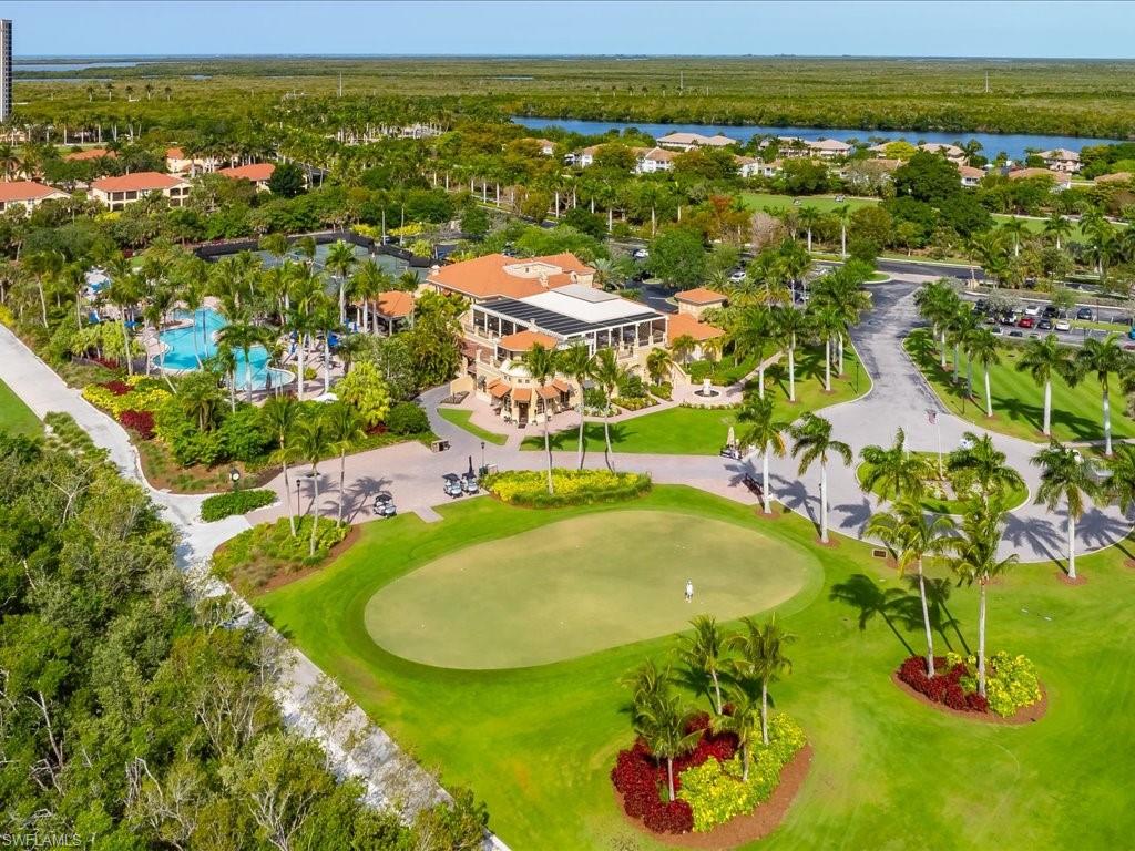1498 Borghese Lane, Unit 101 Naples, FL 34114 - Photo 33 of 34 a view of a swimming pool with a table and chairs