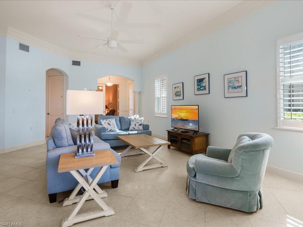 1498 Borghese Lane, Unit 101 Naples, FL 34114 - Photo 10 of 34 a living room with furniture and a flat screen tv