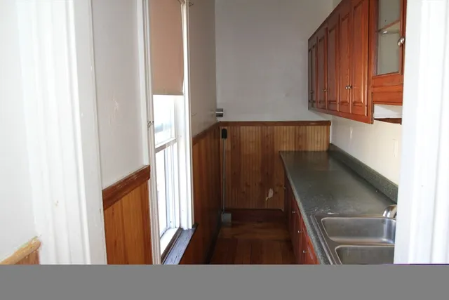a view of a living room with wooden floor and furniture