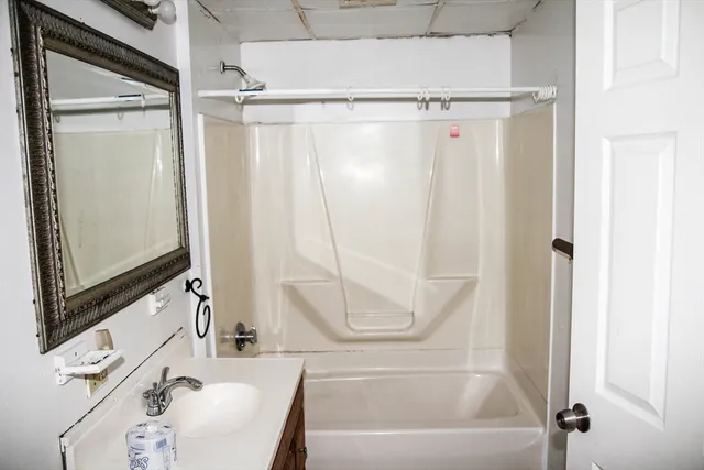 a bathroom with a tub and a shower