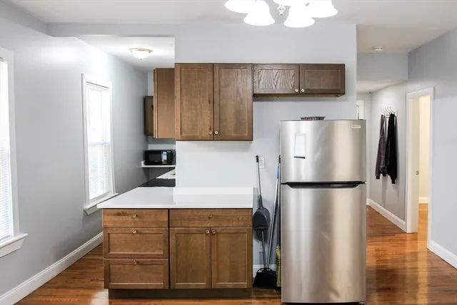 a kitchen with a refrigerator and a microwave