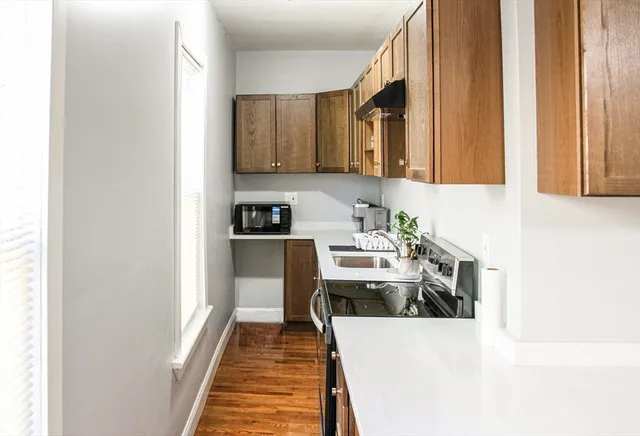 a kitchen with stainless steel appliances a stove a sink and a refrigerator