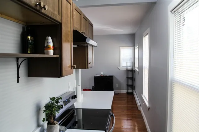 a view of hallway with stairs and wooden floor