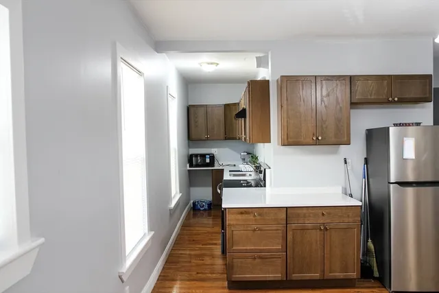 a kitchen with stainless steel appliances granite countertop a refrigerator and a stove top oven