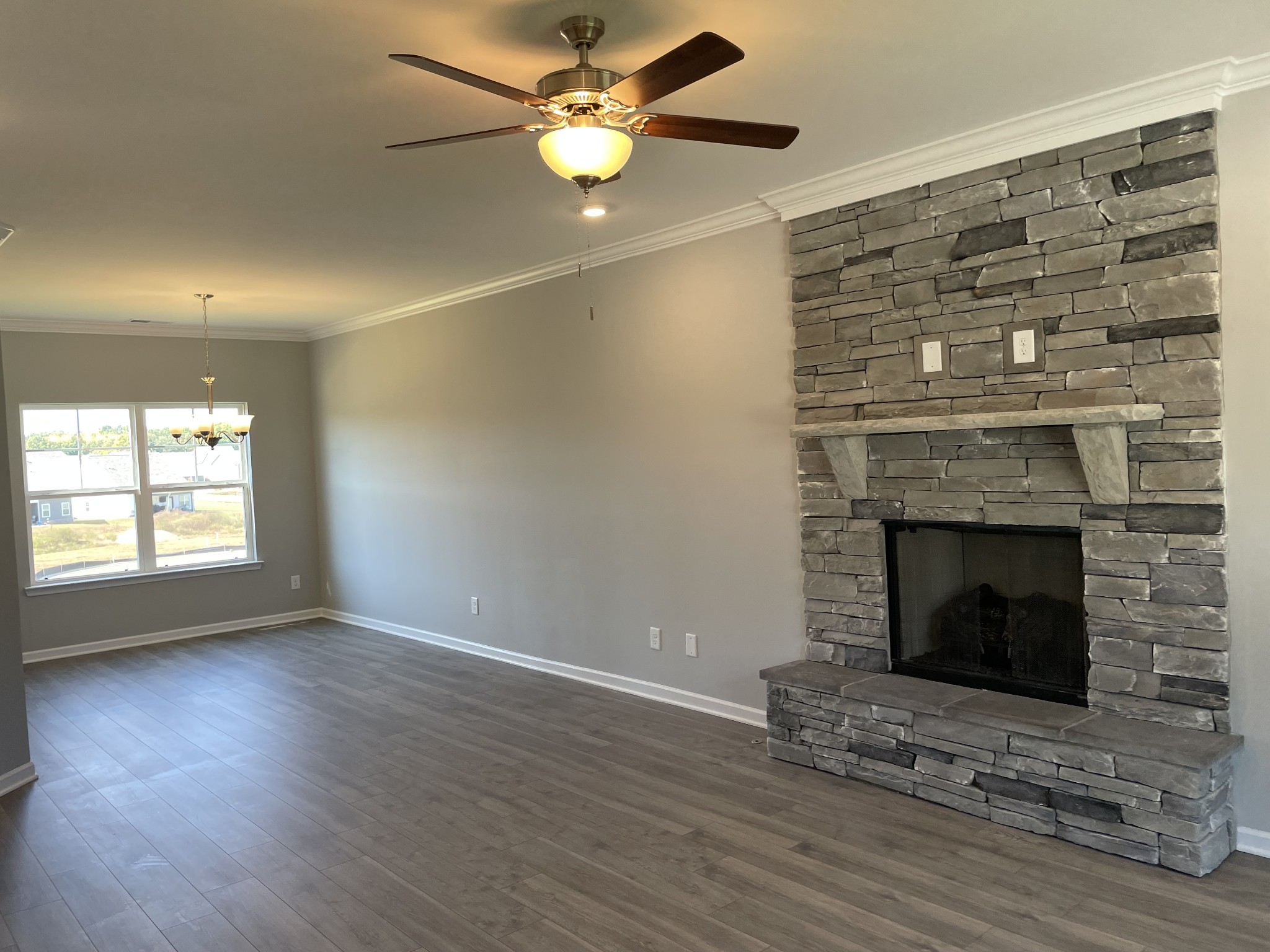 1032 Wiseman Farm Road Fairview, TN 37062 - Photo 2 of 8 an empty room with wooden floor a fireplace and a window