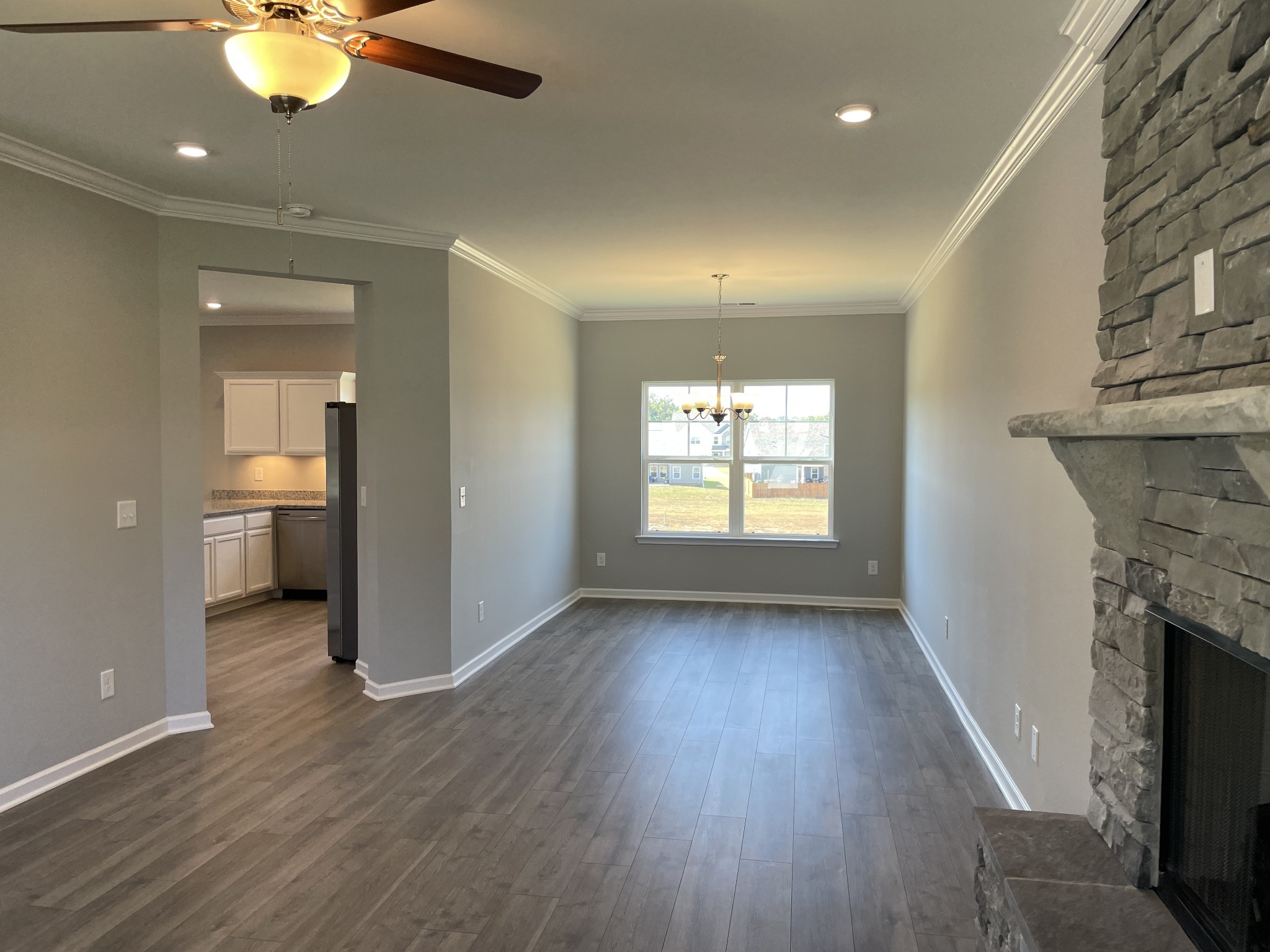 1032 Wiseman Farm Road Fairview, TN 37062 - Photo 3 of 8 an empty room with wooden floor and a fireplace