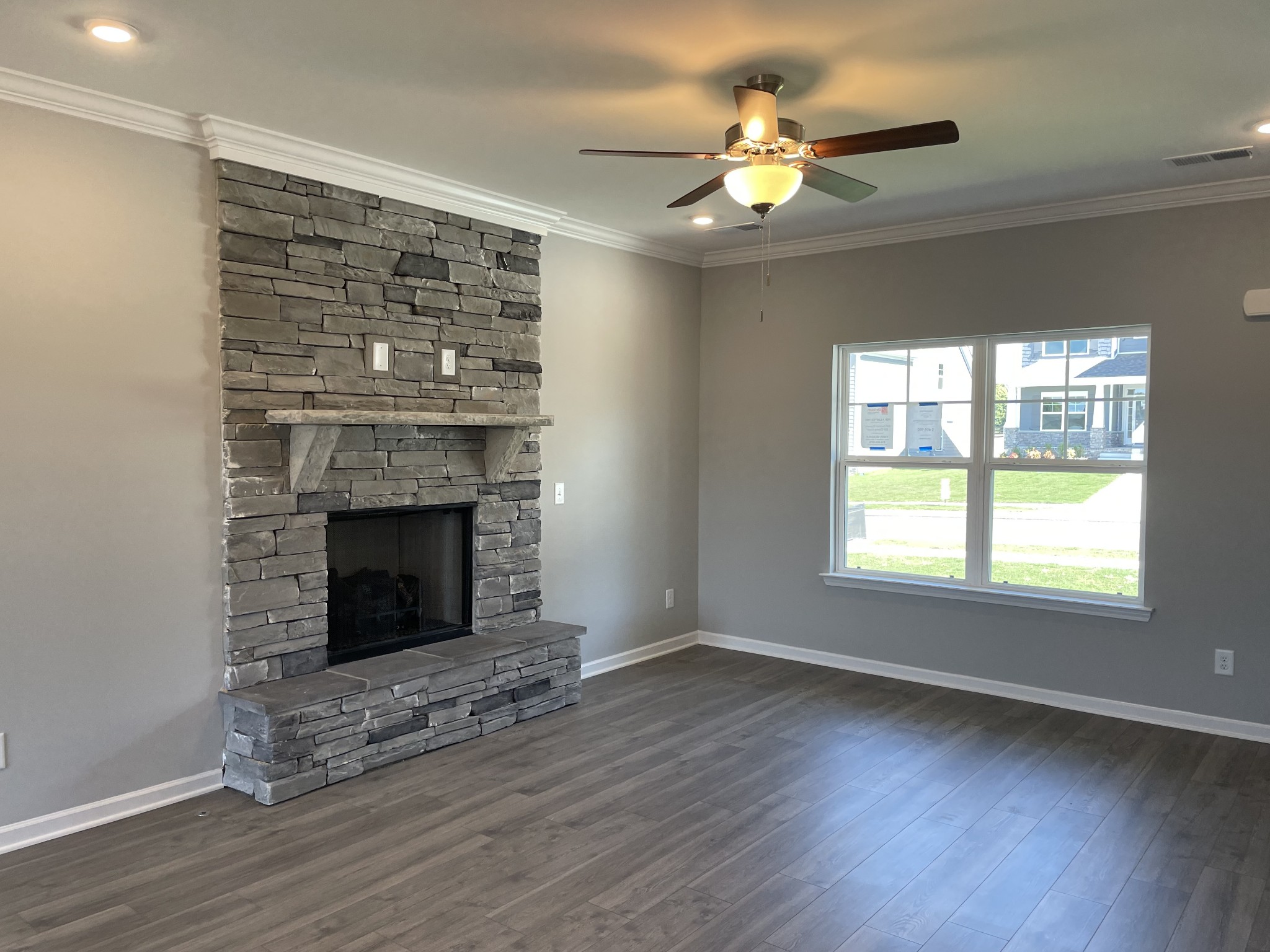 1032 Wiseman Farm Road Fairview, TN 37062 - Photo 4 of 8 a view of an empty room with wooden floor fireplace and a window