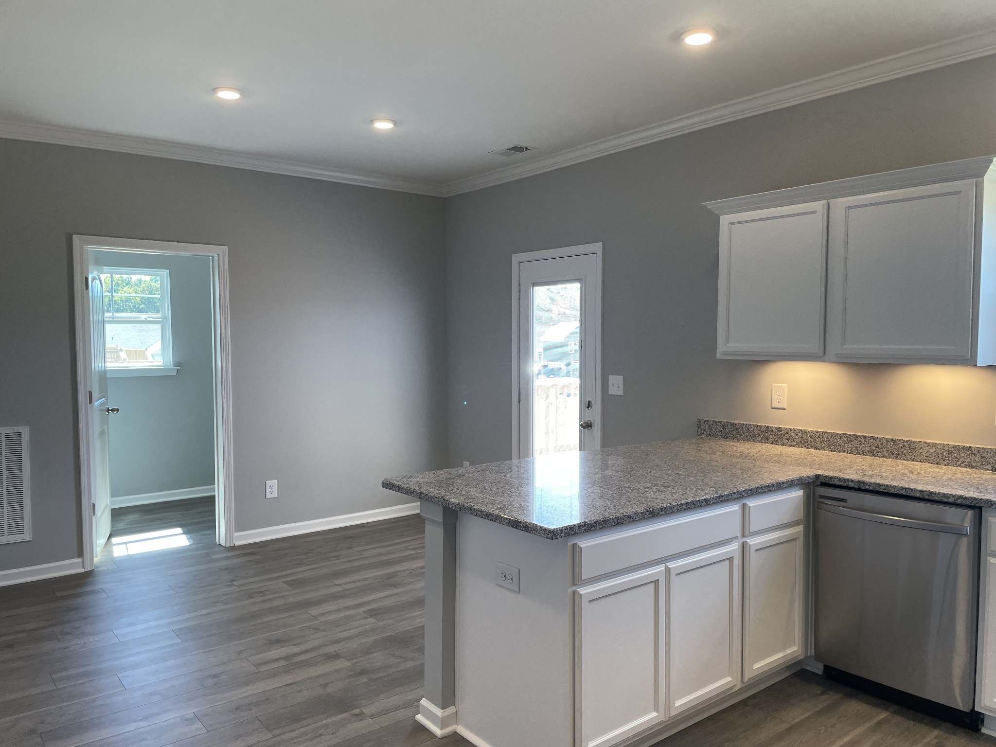 1032 Wiseman Farm Road Fairview, TN 37062 - Photo 5 of 8 a kitchen with stainless steel appliances granite countertop a sink dishwasher and stove with wooden floor