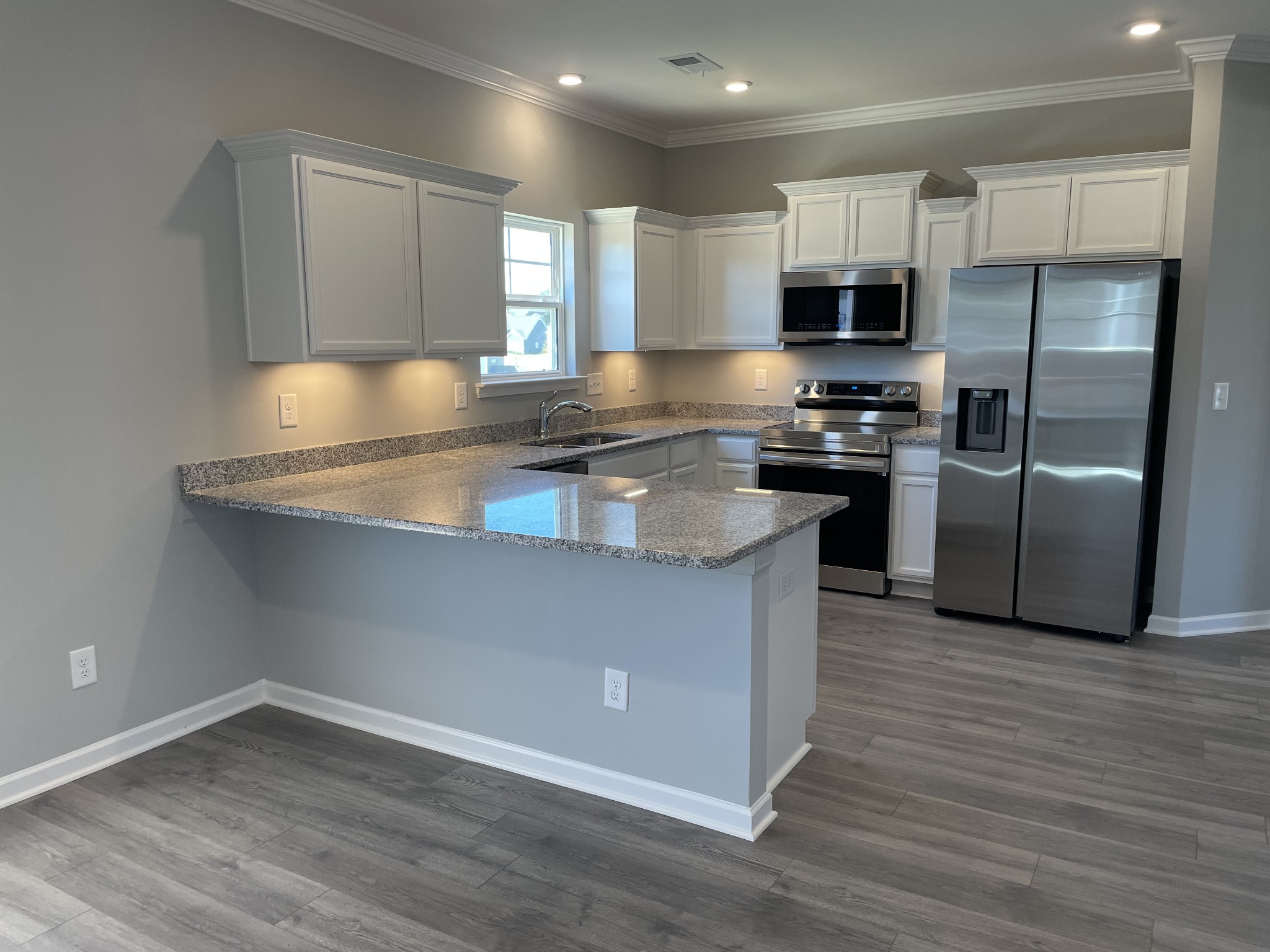 1032 Wiseman Farm Road Fairview, TN 37062 - Photo 6 of 8 a kitchen with stainless steel appliances granite countertop a stove a sink and a refrigerator