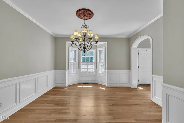a bathroom with a tub double sink window and mirror