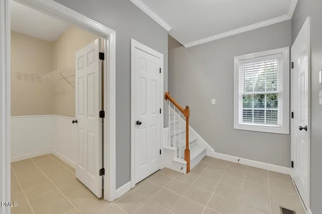 a picture of a bedroom with a white wall and white walls