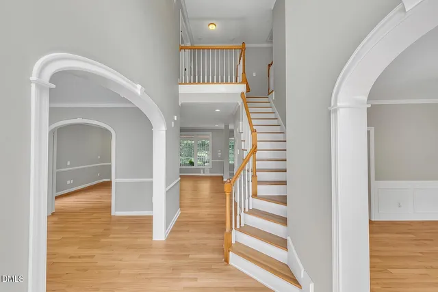 a view of an empty room with a window and fireplace