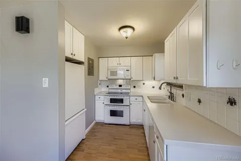 a kitchen with cabinets a sink and appliances