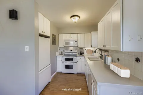 a kitchen with kitchen island a counter top space a sink stainless steel appliances and cabinets