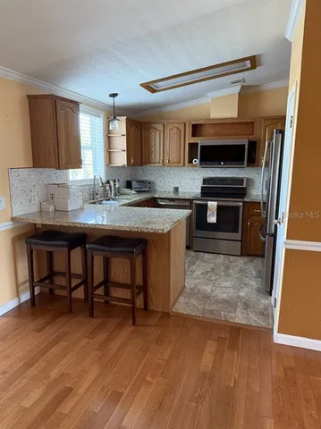 a kitchen with a sink cabinets and wooden floor