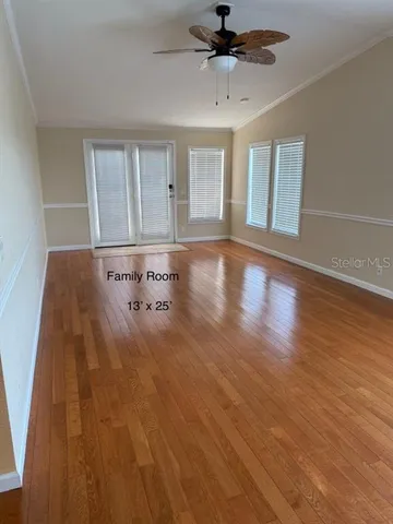 a view of a livingroom with a hardwood floor and ceiling fan