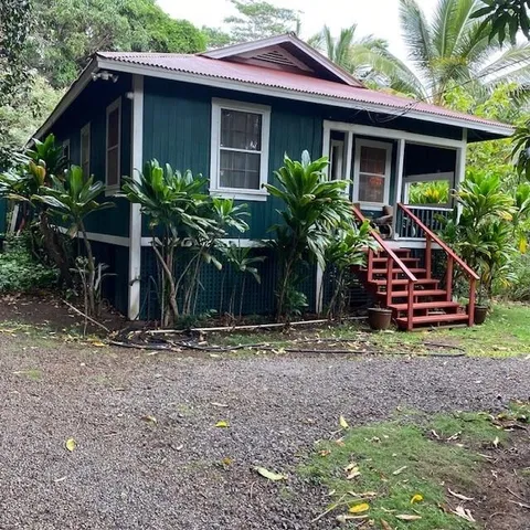 a view of a house with a yard and plants