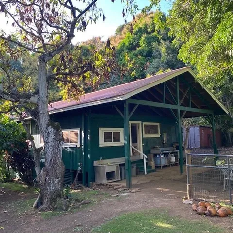 a backyard of a house with barbeque oven fire pit table and chairs