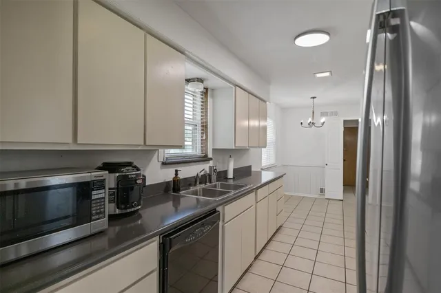 a kitchen with stainless steel appliances a sink stove and cabinets