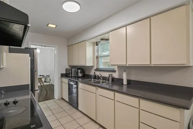 a kitchen with a sink appliances and cabinets