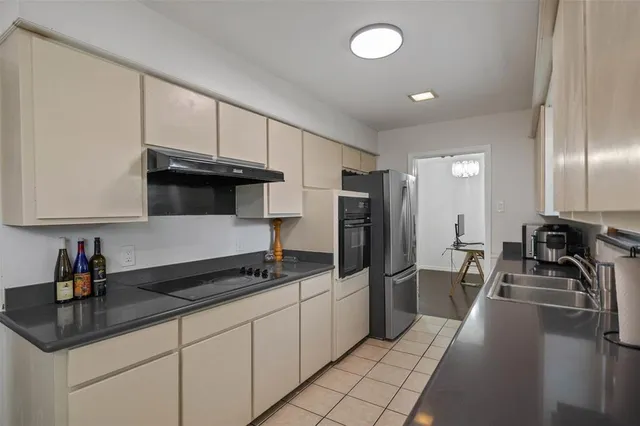 a kitchen with stainless steel appliances a sink stove and refrigerator