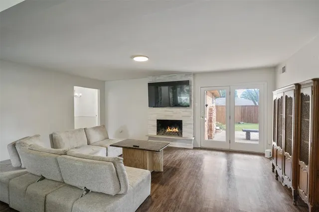 a living room with fireplace furniture and a wooden floor