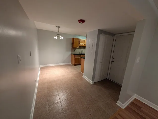 an empty room with windows and cabinet