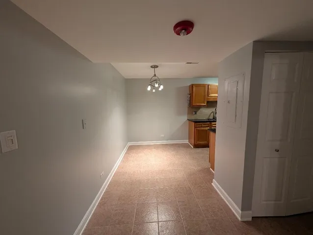a view of a hallway with a refrigerator and a stove
