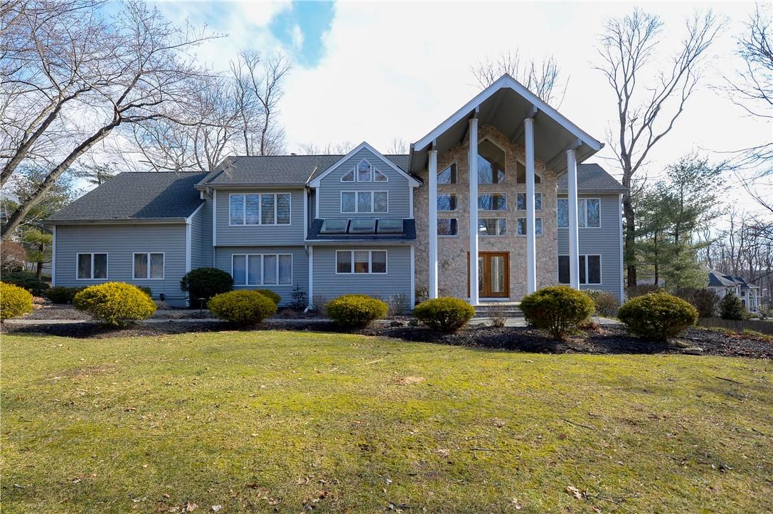 a front view of brick house with yard and outdoor seating