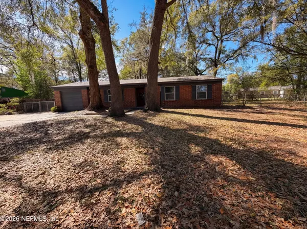 a wooden house with trees in front of it