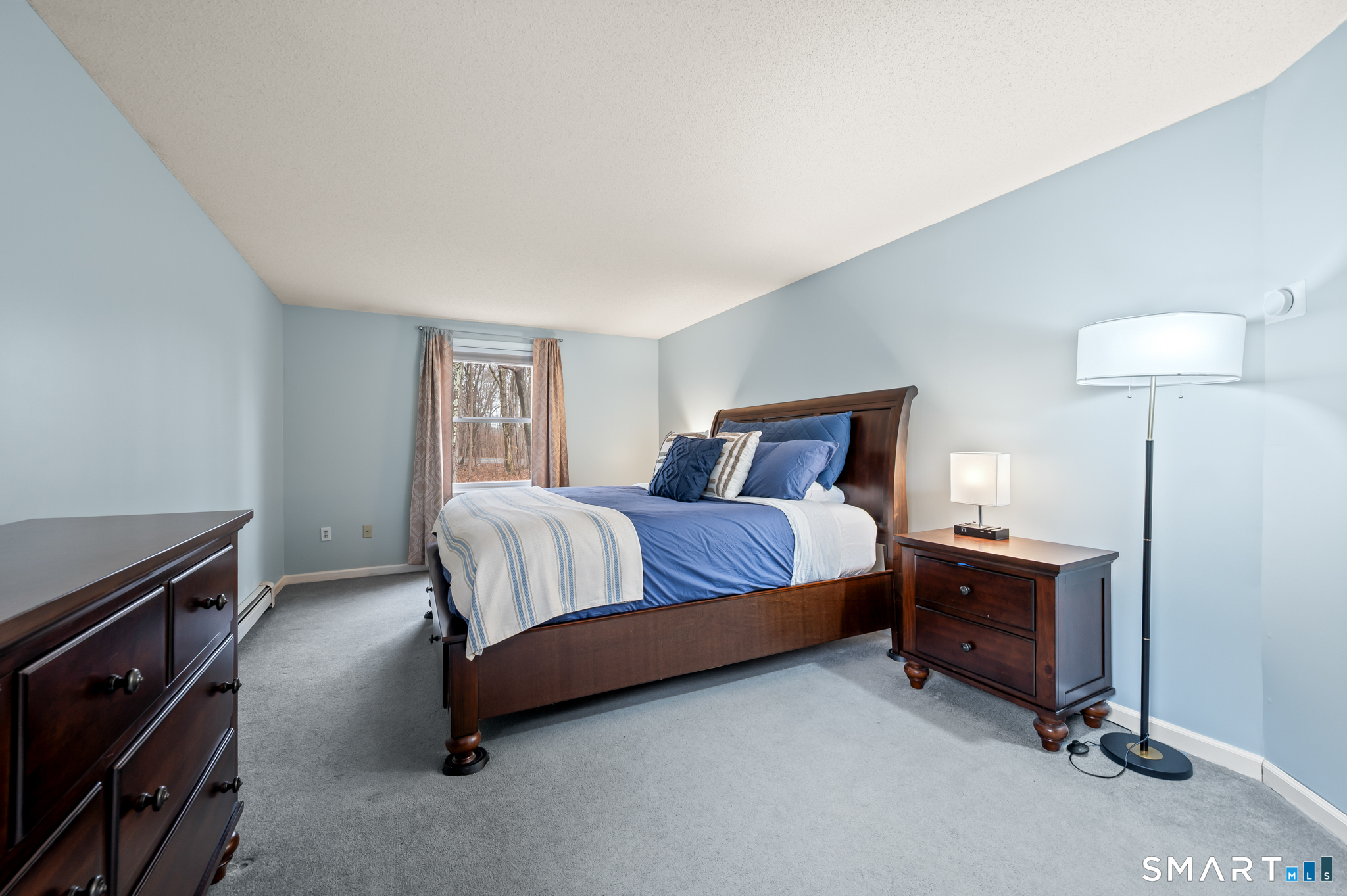 146 Lakeside Drive Andover, CT 06232 - Photo 17 of 35 a bedroom with a bed and a lamp