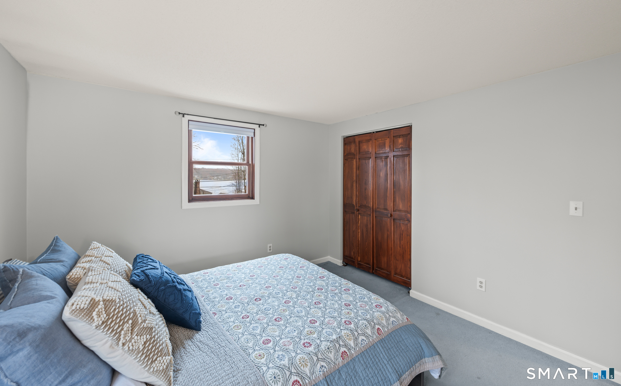 146 Lakeside Drive Andover, CT 06232 - Photo 20 of 35 a bedroom with a bed and a window