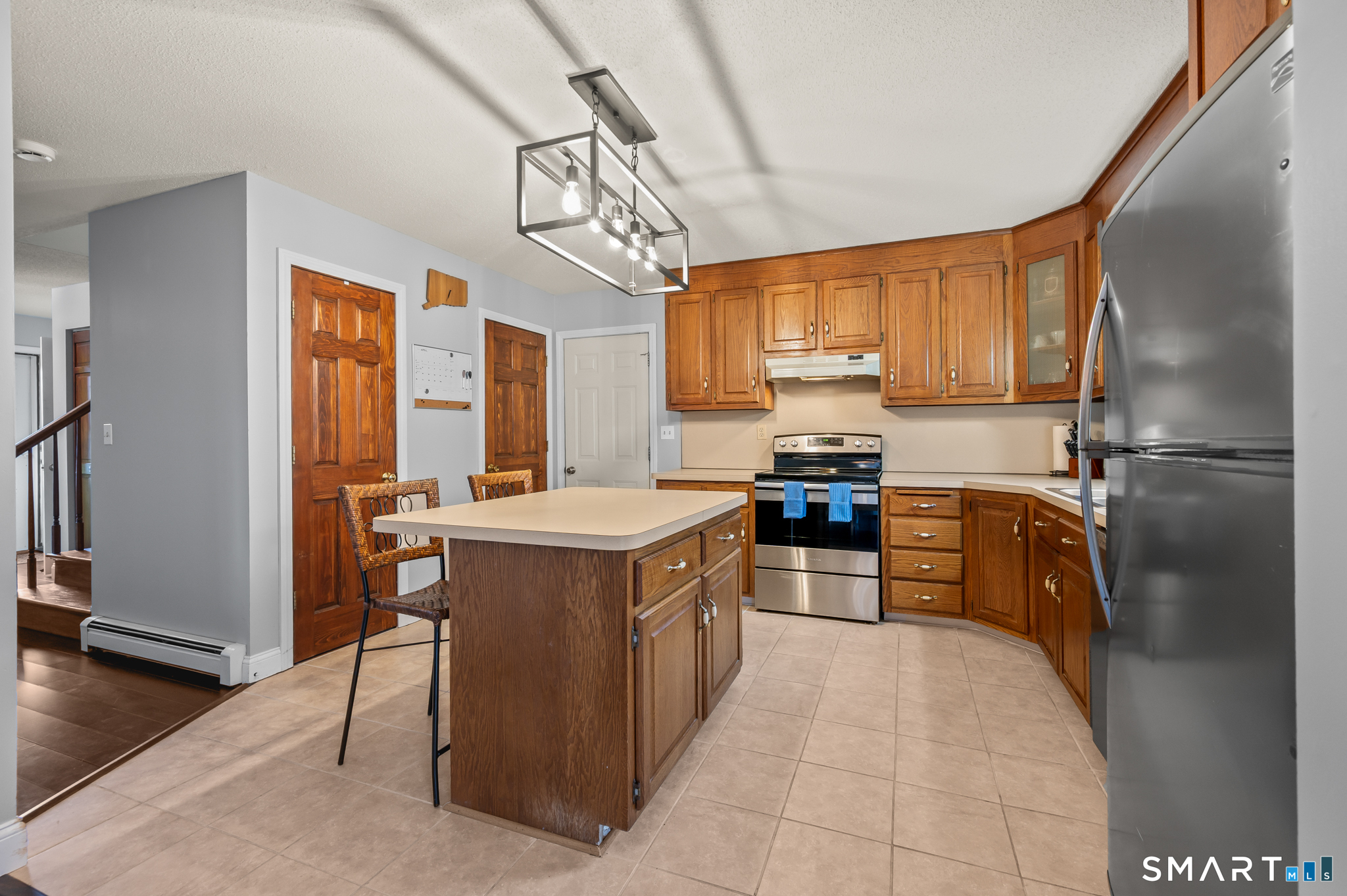 146 Lakeside Drive Andover, CT 06232 - Photo 6 of 35 a kitchen with granite countertop a refrigerator a sink dishwasher a stove and a dining table with wooden floor