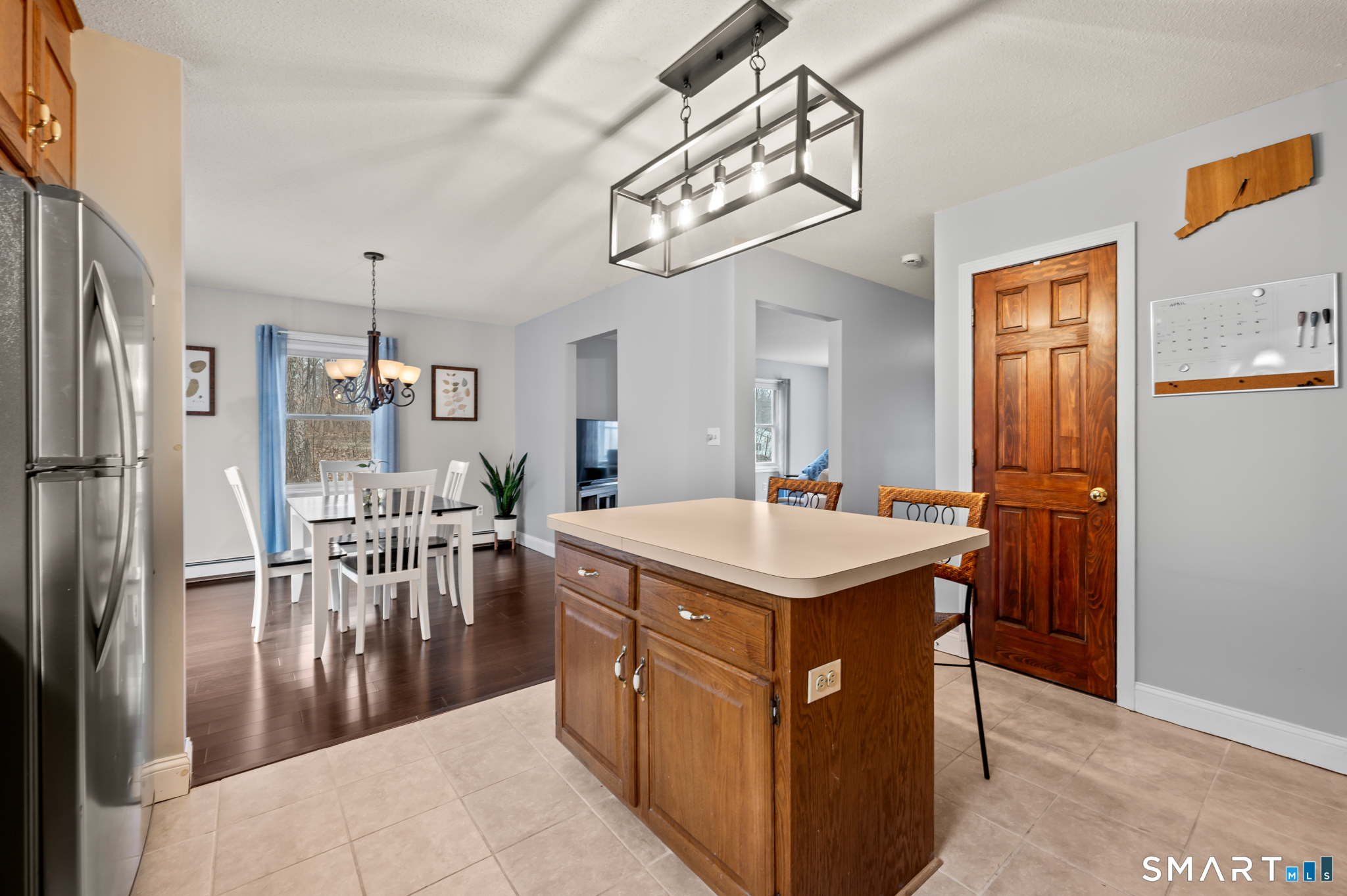 146 Lakeside Drive Andover, CT 06232 - Photo 7 of 35 a kitchen with a table chairs refrigerator and cabinets