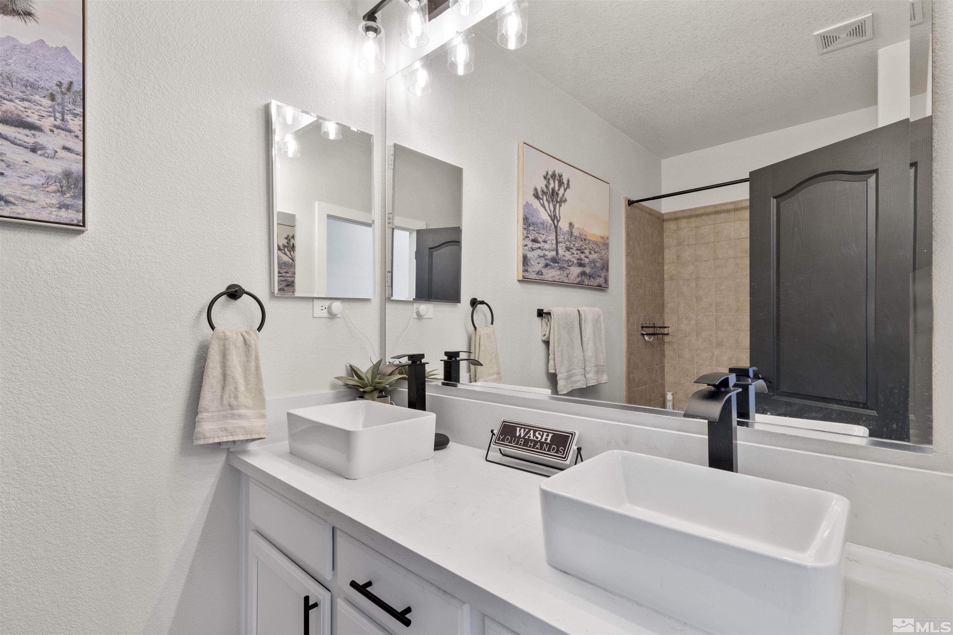 490 Haleb Court Reno, NV 89521 - Photo 20 of 26 a bathroom with a sink and a mirror